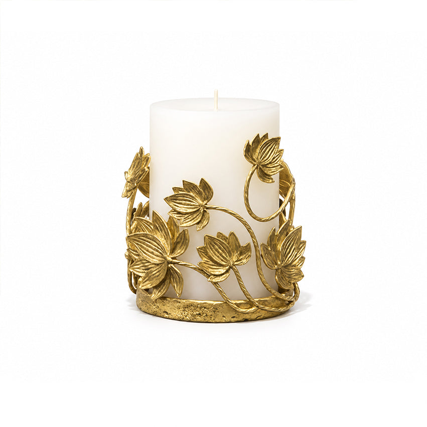 Golden Lotus Candle Holder with gold-toned brass lotus details surrounding a white pillar candle