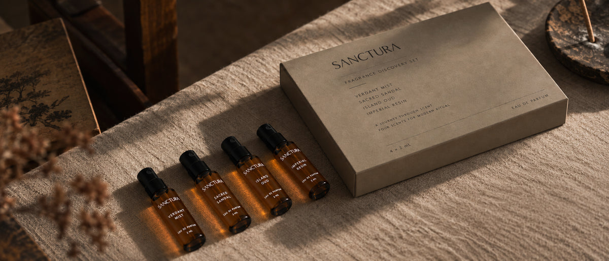 Sanctura Fragrance Discovery Set with four sample vials beside its box on textured fabric.