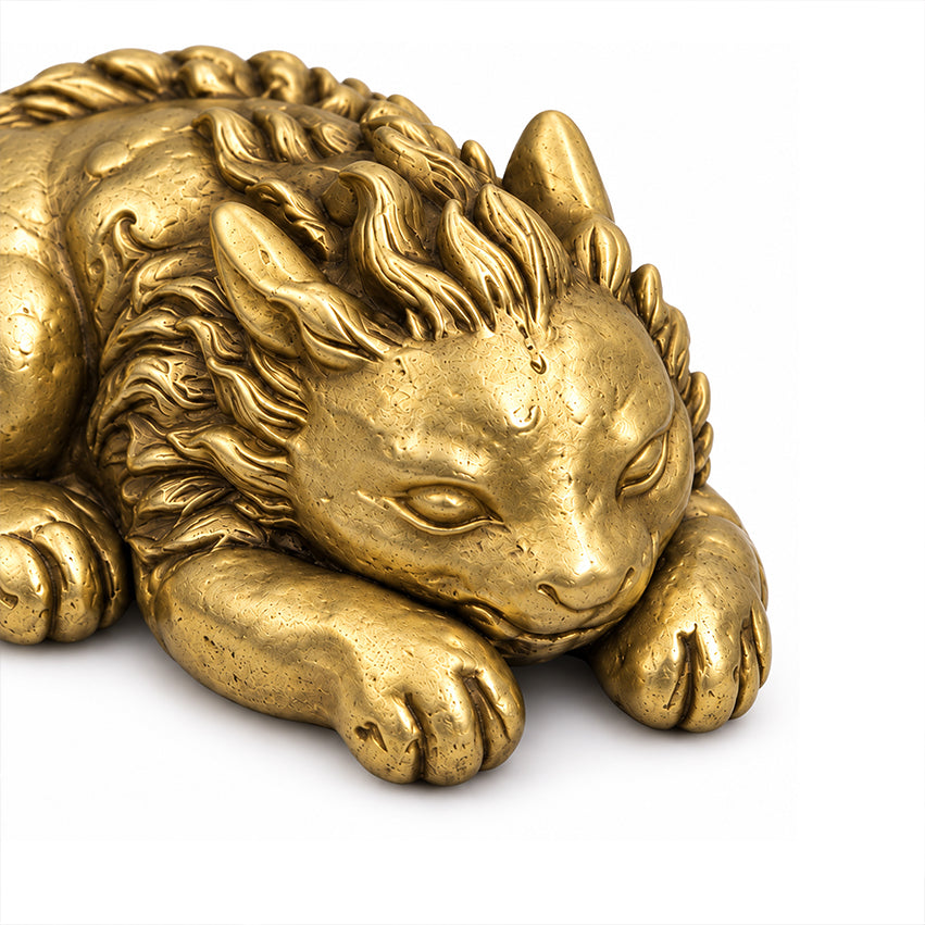 Close-up of the Qilin brass paperweight showing its horn, mane, face and front paws.
