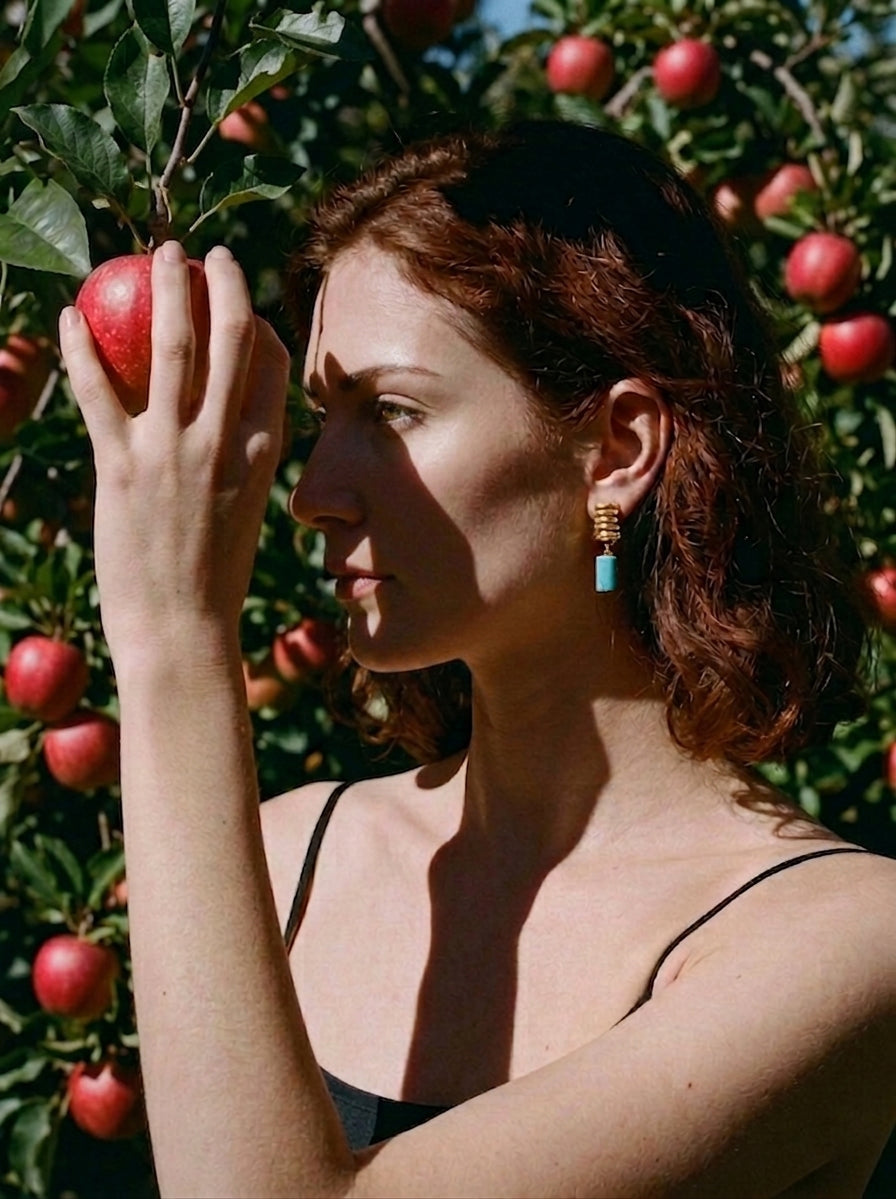 Sanctura earrings worn by a model