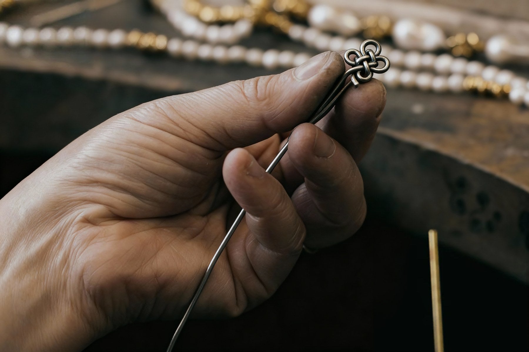 Sanctura artisan forming a decorative metal motif by hand